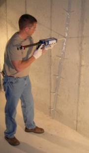 Technician Injecting a Basement Wall Crack