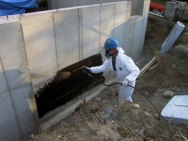 Application of J-Cote Waterproofing to a foundation